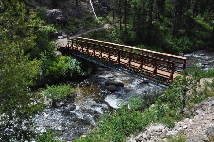 A bridge stretches over a mountain creek