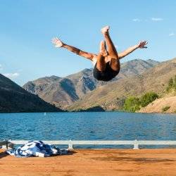 man jumping off dock into the water