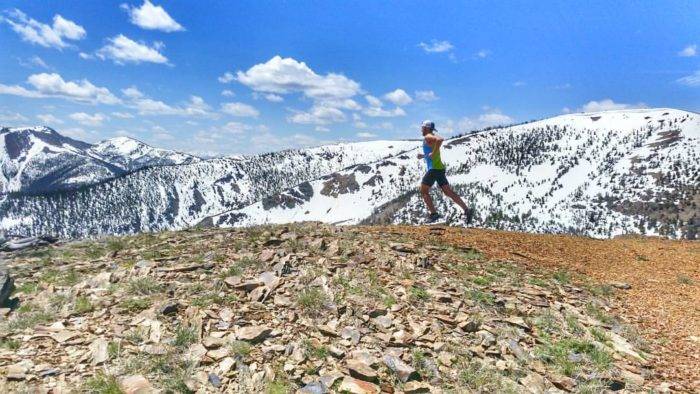 man running along mountain ridge