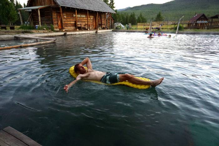 Man floating in hot pool on a raft