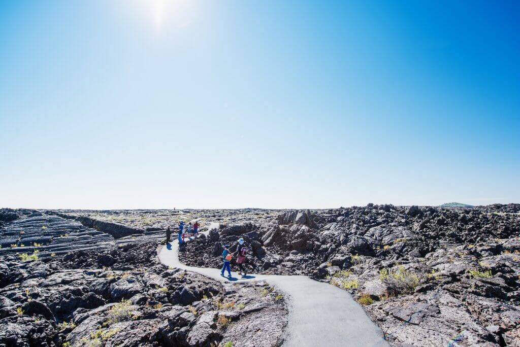 A family walking on a trail at Craters of the Moon.