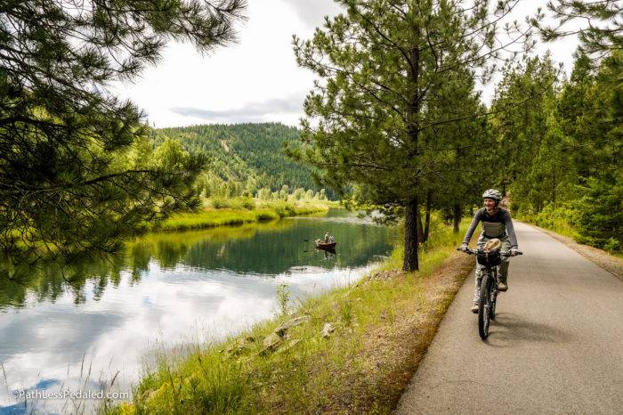 cyclist riding along the river