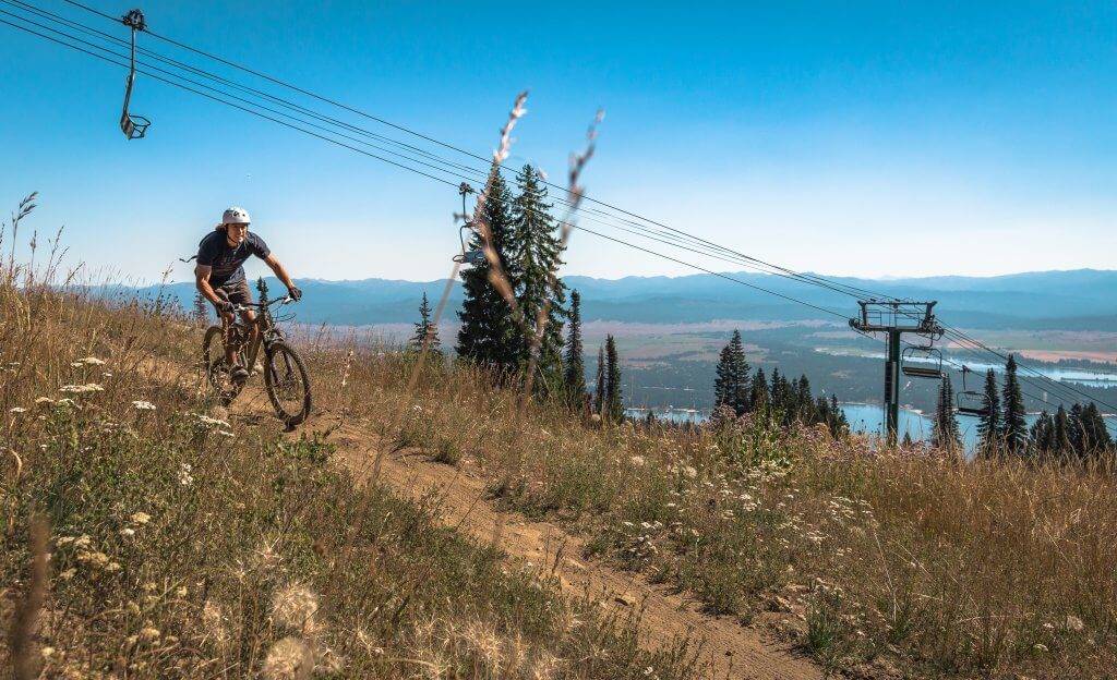 man rides mountain bike on scenic mountain