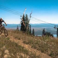 man rides mountain bike on scenic mountain