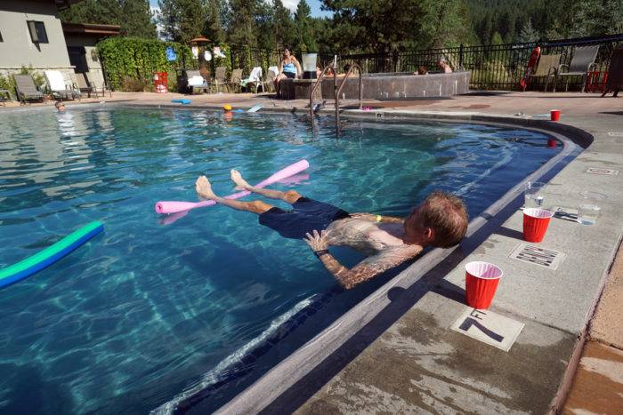 man floats in hot pool