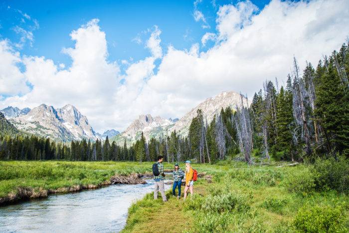 A group of friends hiking along Fishhook Creek Trail near Redfish Lake.