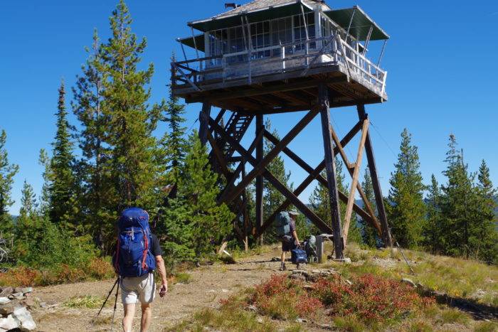 Hikers walking to a fire lookout.