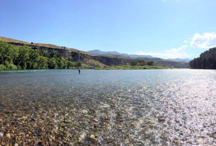 man fly fishing in the river