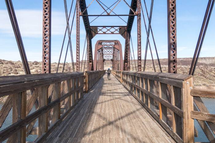 bicyclist riding over bridge at Celebration Park