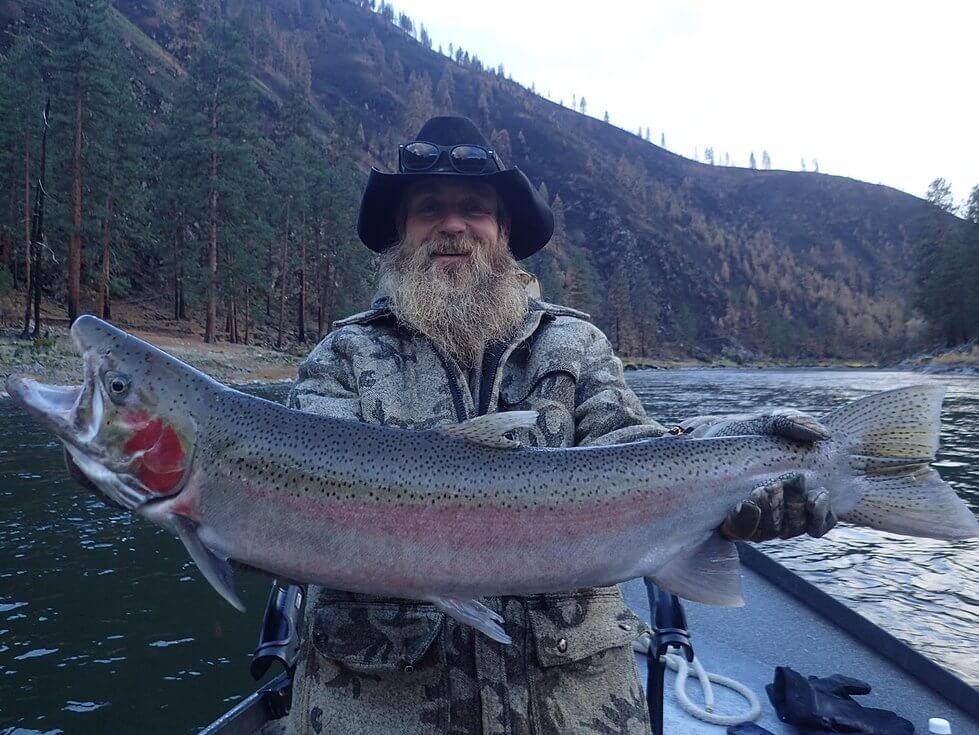 man holding large steelhead