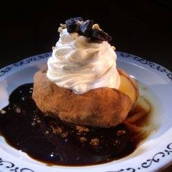 An ice cream potato topped with whipped cream.