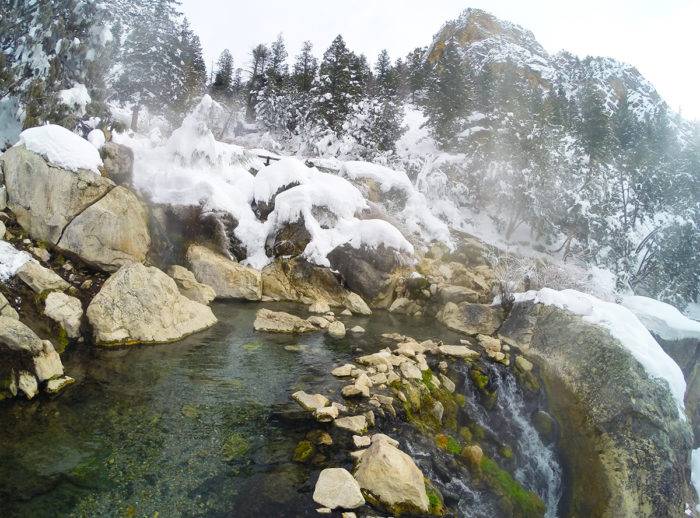 scenic mountain hot pool in the snow.