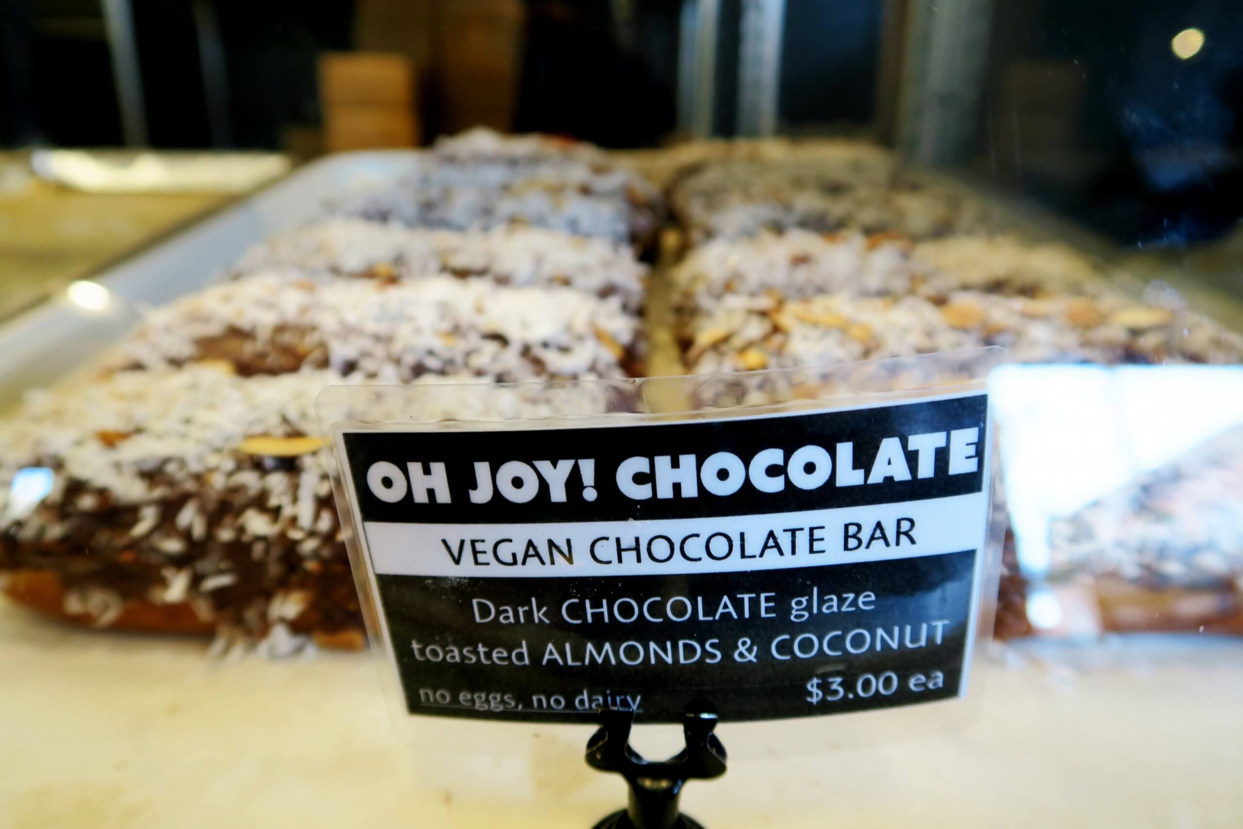 A sign for a vegan chocolate bar.