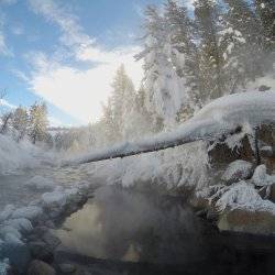 Steam rising from a mountain hot spring.