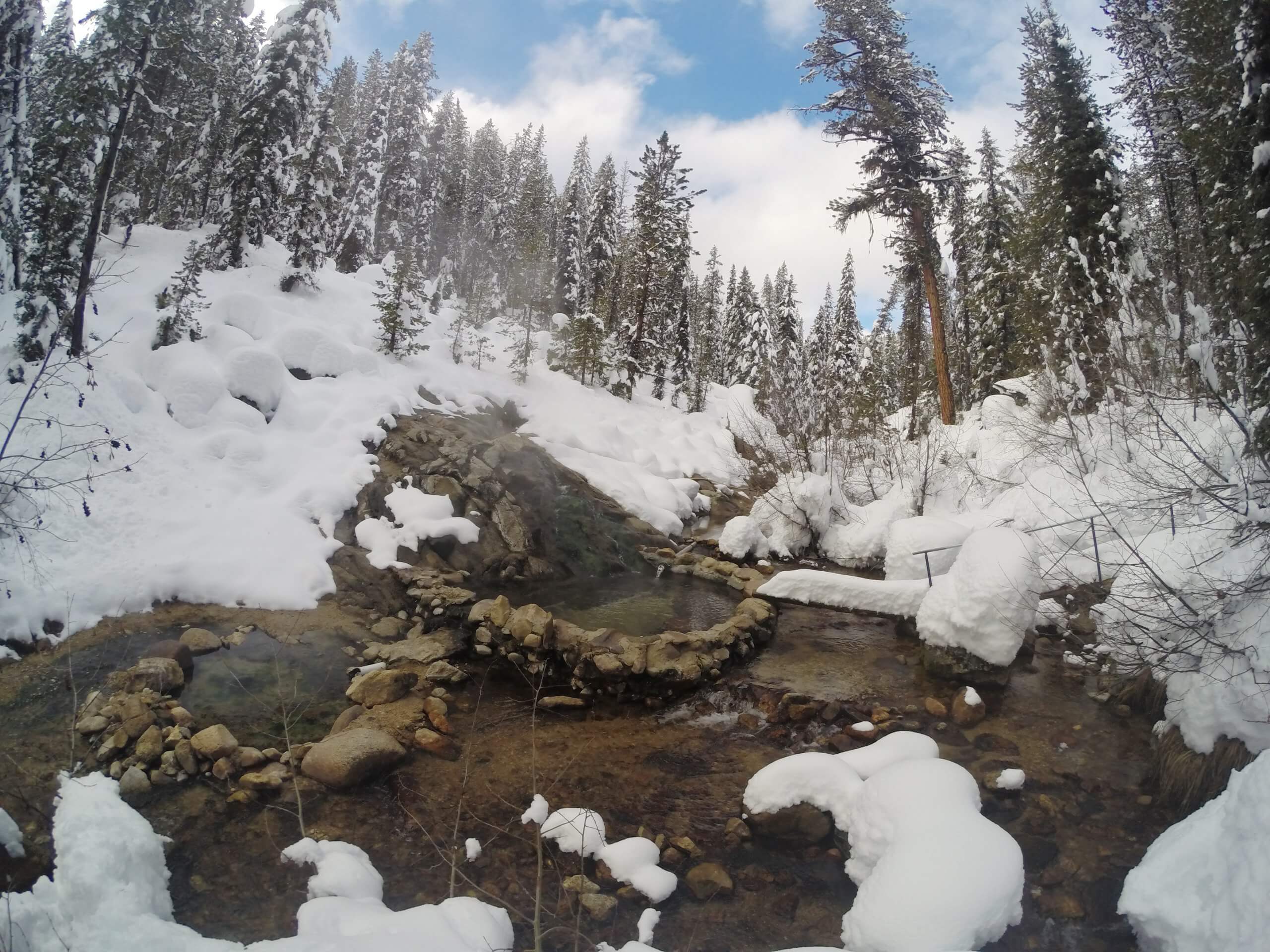 Two mountain hot pools in the snow.