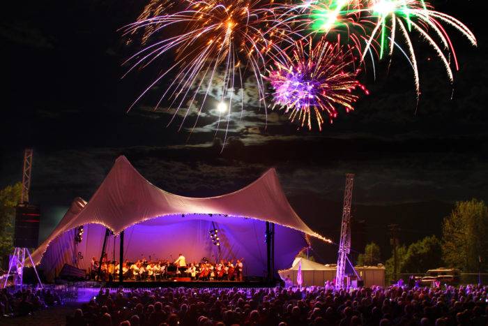 fireworks over an outdoor concert venue.