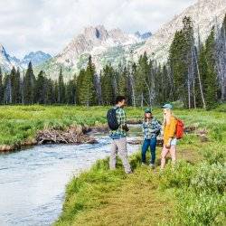 people hiking with mountains in background