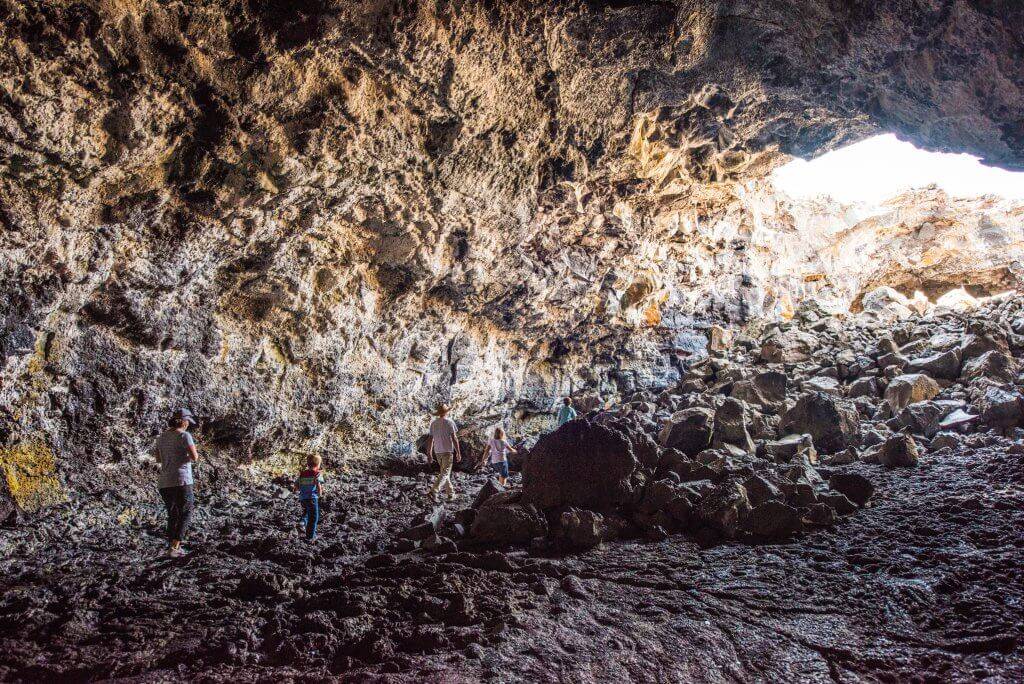 Hiking the lava tubes at Craters of the Moon National Monument and Preserve, Near Arco. Photo Credit: Idaho Tourism