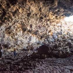 Hiking the lava tubes at Craters of the Moon National Monument and Preserve, Near Arco. Photo Credit: Idaho Tourism