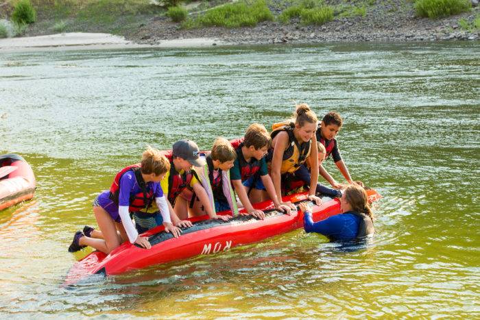 Kids playing on an inflatable kayak