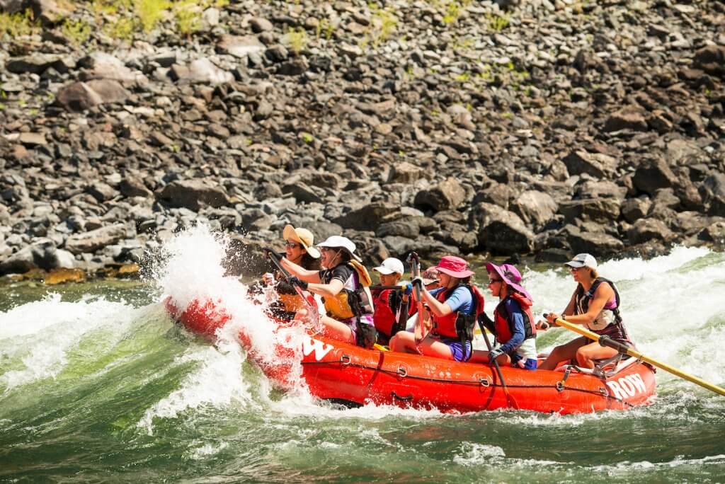 group of rafters going through a whitewater rapid