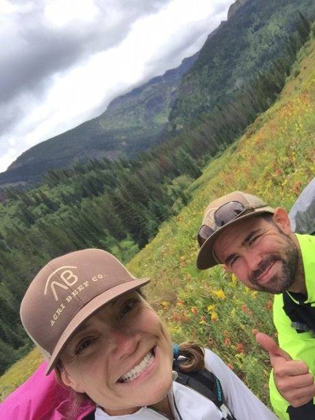 TWO HIKERS IN A MEADOW