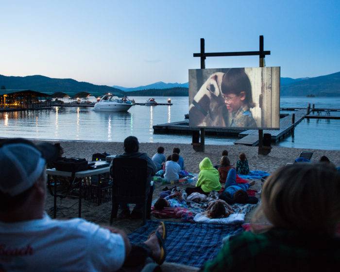 outdoor movie screen on the beach at a lake