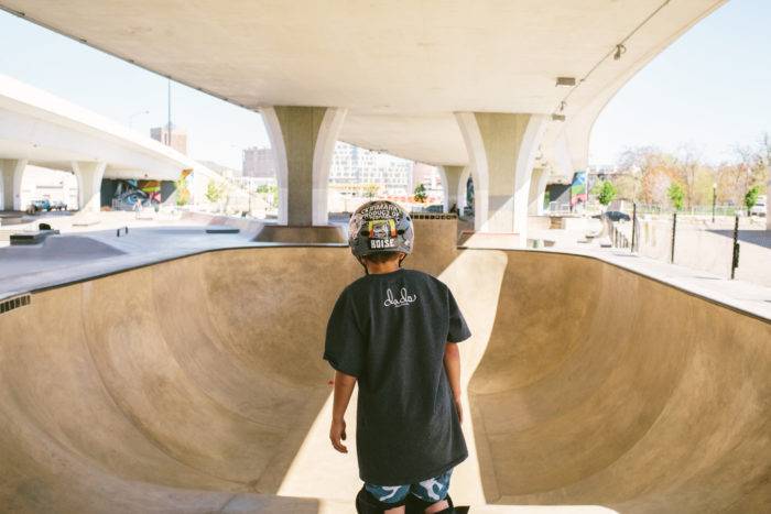 skater getting ready to drop into a bowl in skate park