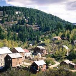 An aerial view of the many wooden historical buildings and forest areas within the mountains in Silver City.