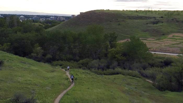 A person in blue rides a bike along a trail at the Ridge to Rivers Trail System in Boise.