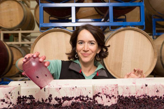 woman next to fermenting grapes