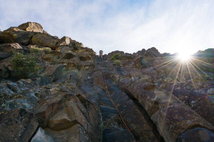 Climber on rocky cliff