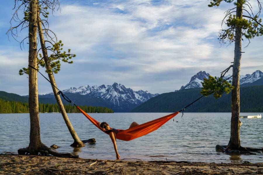 woman in hammock next to a lake