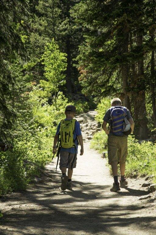 boys hiking on a mountain trail