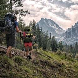 hikers in rugged mountain peaks.