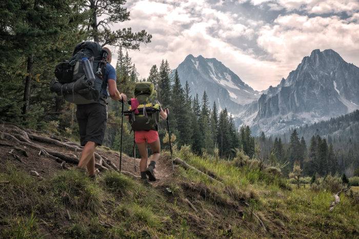 hikers in rugged mountain peaks.