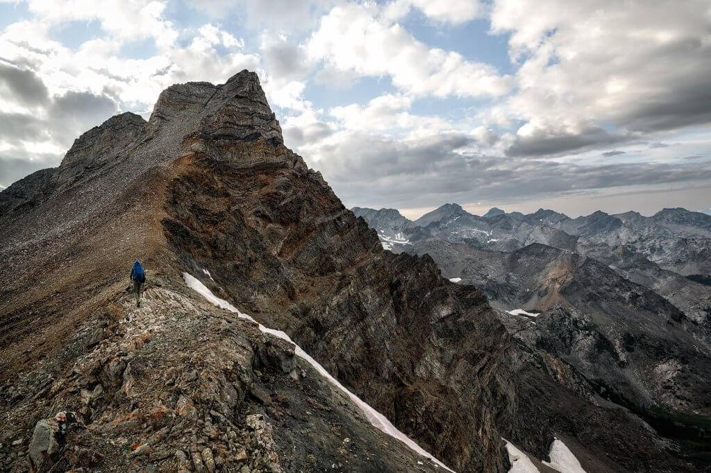 A person hikes up the summit of Old Hyndman Peak.