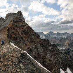 A person hikes up the summit of Old Hyndman Peak.