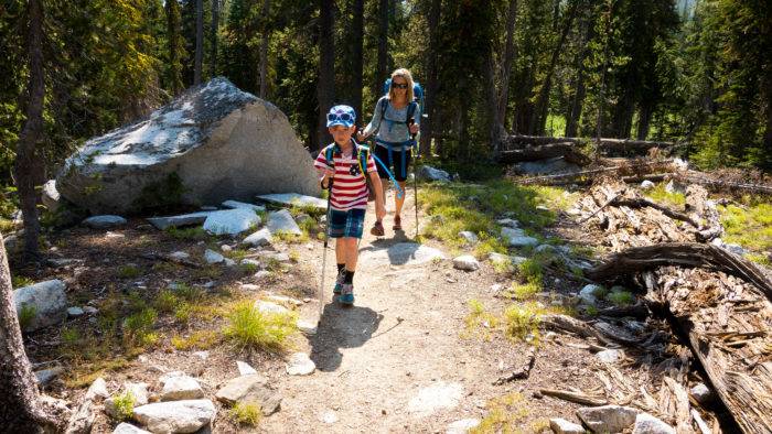 mom and son walking on mountain path