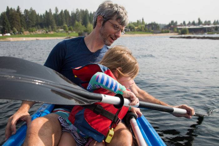 dad and daughter paddling kayak