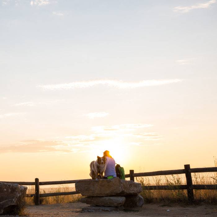 WOMAN AND DOG AT SUNSET