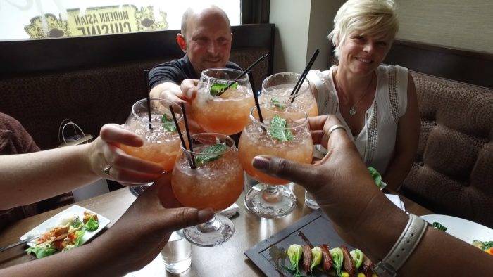 group of people raising glasses.