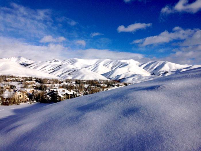 snowy mountains with town in the valley