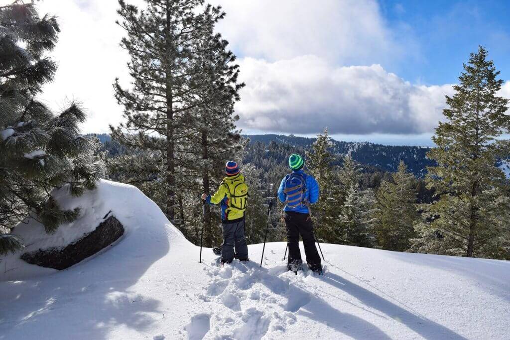 Three people exploring family-friendly snowshoe trails.