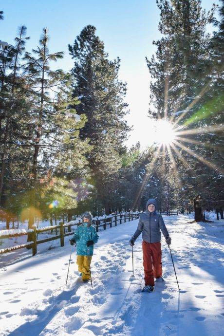 Two people exploring family-friendly snowshoe trails.