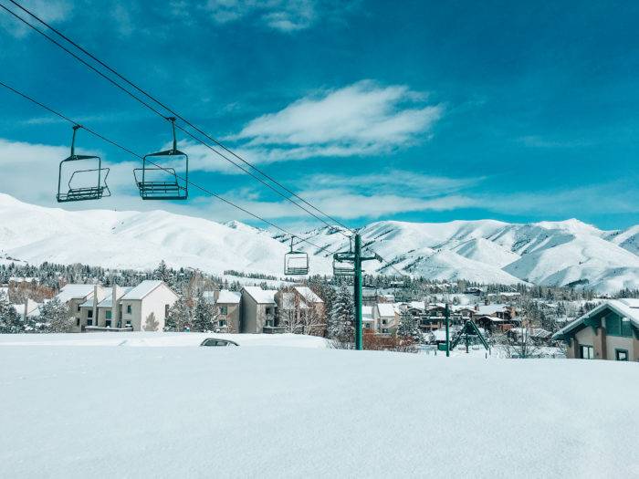 snowy mountains with chairlift in foreground