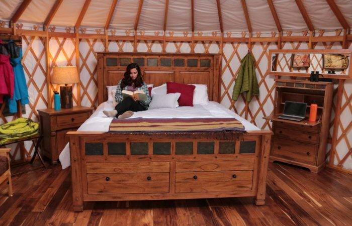 woman sitting on bed in yurt