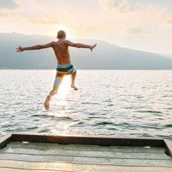 Jumping off a dock at sunset.