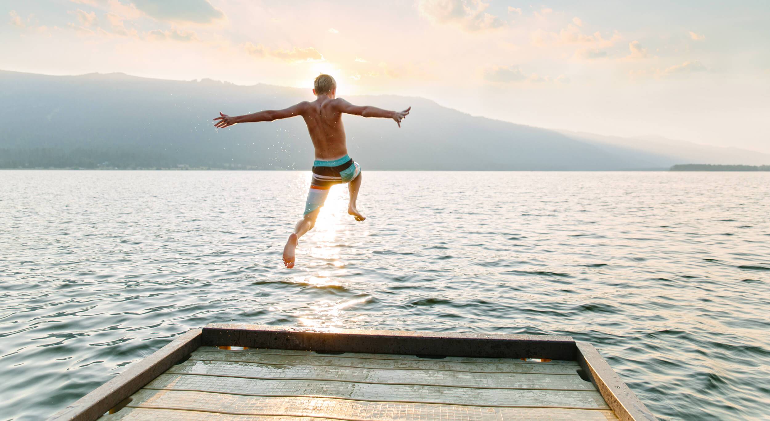 Jumping off a dock at sunset.