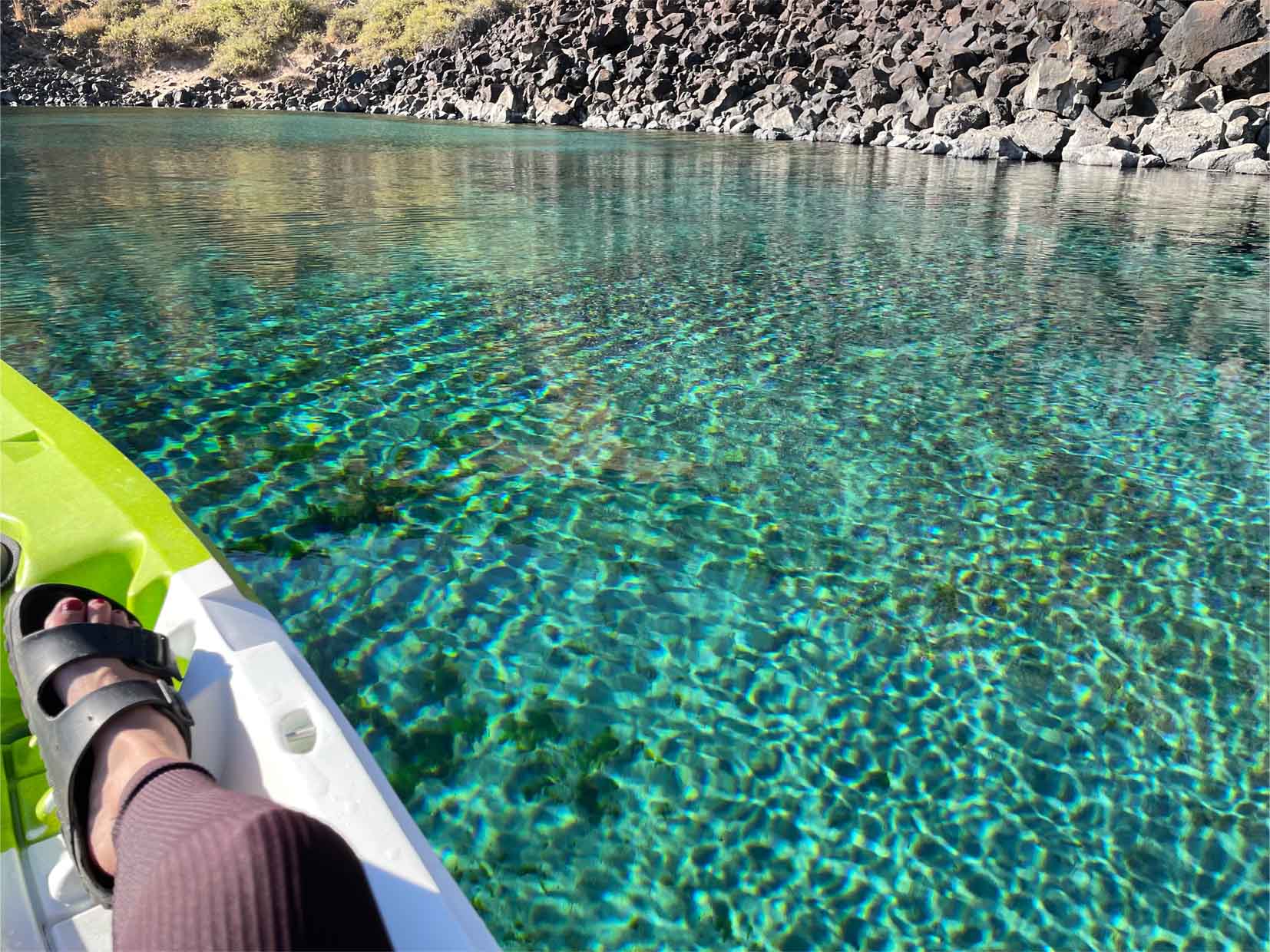 The jeweled turquoise waters ripple as a kayak glides across the Blue Heart Springs along the Snake River.